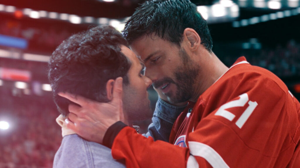 Heated Rivalry | Cena de François Sagata segurando na nuca de Robbie Graham-Kuntz. Os dois olham profundamente para beijar a boca do outro | Dandy Souza